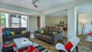 a living room with a couch and a table at Harbour Town Haven Spacious 4Bd 4Ba Retreat in Hilton Head Island