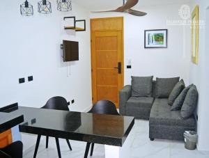 a living room with a table and a couch at HOTEL PALENQUE PREMIER in Palenque