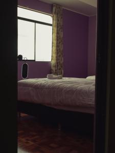 a bedroom with a bed and a window at Casa Hotel Místico in Ayacucho