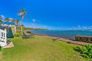 a view of the ocean from the backyard of a house at Kauai Aliomanu home in Anahola