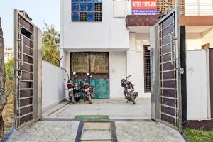 two motorcycles parked in front of a building at OYO Hotel Expo Inn in Noida