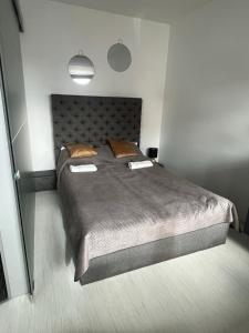 a bedroom with a large bed with two pillows at Wake Up To Baltic Views AON Apartment Just Minutes From Beach in Gdańsk