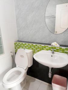 a bathroom with a white toilet and a sink at Changsi Resort-Krabi in Krabi town