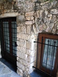 a stone building with a door and a window at Il Fontolo in Ponzano Superiore