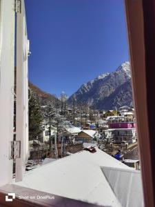 a view of a city with mountains in the background at Montanamar Lachung in Lachung