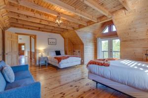 a bedroom with two beds and a couch in a room at Secluded 18-Acres with Pool Hot Tub Pool Table in Fairview
