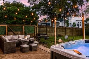 a backyard with a jacuzzi tub in a yard at Hip East Nashville Cottage w HOT TUB Mins to DWNTN in Nashville