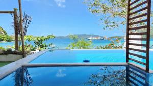 a swimming pool with a view of the water at Padayon Bed 'N Breakfast in Romblon