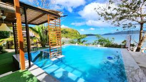 a swimming pool with a view of the water at Padayon Bed 'N Breakfast in Romblon