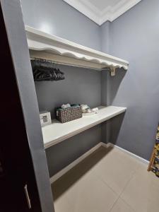 a walk in closet with a white shelf at Paradise Haven at Hamptons - -across from Ac Marriot Hotel in Kingston