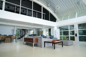 a living room with a large glass ceiling at Beach House Resort Goa in Benaulim