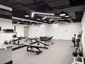 a gym with several exercise equipment in a room at Silkhaus Modern 1BDR by Emirates Tower Metro in Dubai