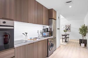 a kitchen with a sink and a washing machine at Silkhaus High Floor in Millennium Executive Tower in Dubai