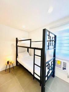 a room with two bunk beds and a table at Artscapes by Kavanah Suites in Batangas City
