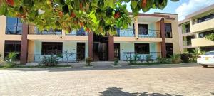 a building with a car parked in front of it at Cosy Living in Gulu