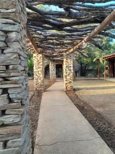 a stone wall with a pathway in a park at Karongwe River Lodge in Karongwe Game Reserve