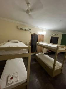 a room with three bunk beds in it at THE ALP HOTEL Bypass Road in Madurai
