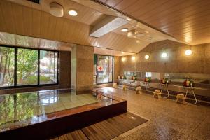 a large room with a waiting room with benches and windows at Royal Hotel Kawaguchiko in Fujikawaguchiko