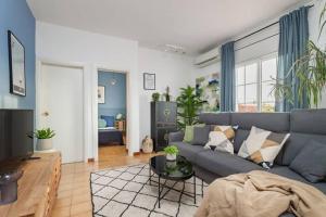 a living room with a couch and a table at City View Penthouse - 2 Bedroom Suite in Barcelona