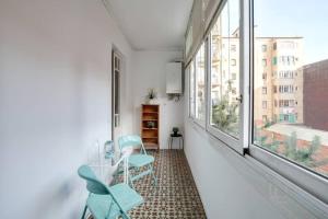 a room with two chairs and a table and windows at Sagrada Familia- Emblematic and Charming Catalan Home in Barcelona