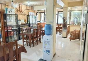 a restaurant with a water heater in the middle of a room at Querencia Inn in Banaue
