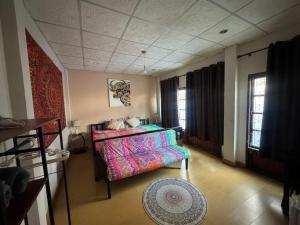 a living room with a bed and a couch at Villa’s Homestay in Chiang Mai