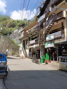 a building with signs on the side of a street at Querencia Inn in Banaue