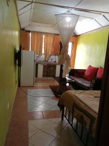 a living room with a couch and a table at Yaya kilimani cottage B in Nairobi