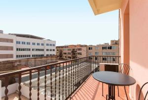 a balcony with a table and a view of a city at 3BD in Poblenou next to the beach in Barcelona