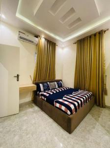 a bedroom with a large bed in front of a window at Where Luxury Meets Comfort in Lagos