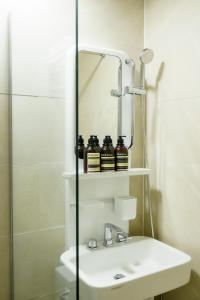 a bathroom with a sink and a mirror at The Stay Hue Myeongdong in Seoul