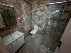 a bathroom with a shower and a toilet and a sink at Liza Suit Hotel in Istanbul