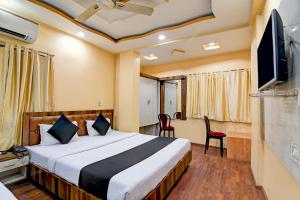 a hotel room with a bed and a tv at BRILL A G STAR 500m from International Airport in kolkata