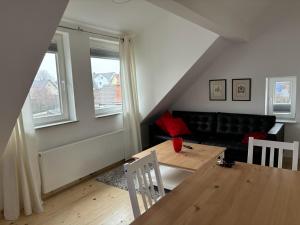 a living room with a table and a couch at Wick Home Apartment 3 Lahr-Burgheim in Burgheim
