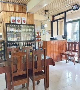 a restaurant with a counter with chairs and a bar at Querencia Inn in Banaue