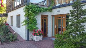 a house with a door and flowers on it at Prie Galvės in Trakai