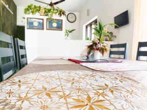 a dining room table with a table cloth on it at Alma Homestay in Mararikulam