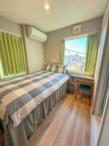 a bedroom with a bed and a large window at SHINJUKU WARM HOUSE in Tokyo