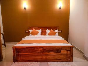 a bedroom with a large wooden bed with pillows at Ella, Nine Glow Resort in Ella