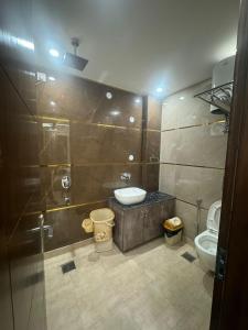 a bathroom with a shower and a toilet at Hotel Royal Oakes - East of Kailash in New Delhi