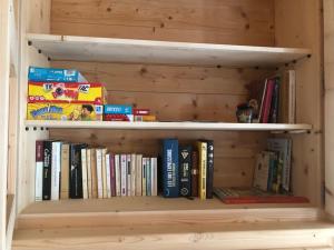 a book shelf full of books in a room at Belle maison traditionnelle - Les Chavonnes in Courchevel