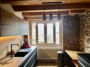 a kitchen with a sink and a window at Belle maison traditionnelle - Les Chavonnes in Courchevel
