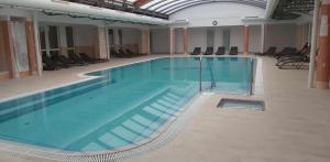 a large swimming pool in a large building at D&D Wellness Apatmanok - Dani Wellness Apartman in Zalakaros