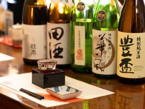 a group of bottles of wine on a table at Tabist Hirosaki Touei Hotel in Hirosaki