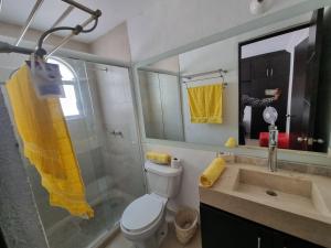 a bathroom with a toilet and a sink and a mirror at Casa con alberca Lomas de San Pedro SD in Querétaro