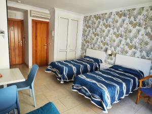 Posteľ alebo postele v izbe v ubytovaní Apartamentos Caracas