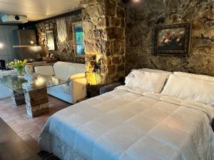 a bedroom with a bed and a stone wall at “Un Luogo Magico” in Marostica