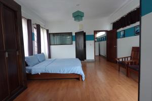 a bedroom with a bed in the middle of a room at CHILCHILL Elite Residences BKK2 in Phnom Penh