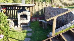 a garden with a stone oven in a yard at Prie Galvės in Trakai