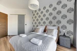 מיטה או מיטות בחדר ב-Szafarnia DeLuxe Apartment Apartinfo